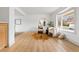 Bright living room featuring ample natural light, modern decor, and hardwood floors flowing to the dining area at 3930 S Spruce St, Denver, CO 80237