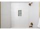 Shower area featuring sleek white tiles and a decorative nook, creating a clean and modern aesthetic at 3930 S Spruce St, Denver, CO 80237