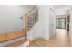 Modern staircase with light wood steps and a decorative black and wood railing at 3930 S Spruce St, Denver, CO 80237