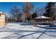 Snowy backyard with a wooden gazebo at 900 Emerald St, Broomfield, CO 80020