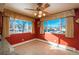 Bright dining area with red walls and view from large windows at 900 Emerald St, Broomfield, CO 80020