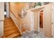 Inviting entryway with wood staircase, tile flooring, and access to a sauna at 900 Emerald St, Broomfield, CO 80020