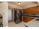 Kitchen features stainless steel refrigerator and wood cabinets at 900 Emerald St, Broomfield, CO 80020