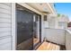 Private balcony featuring wood floors, screen door and an air conditioning unit at 10150 E Virginia Ave # 7-302, Denver, CO 80247