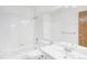 Bright bathroom includes white tile, large mirror, and a vanity with storage at 10150 E Virginia Ave # 7-302, Denver, CO 80247