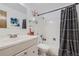 A well-maintained bathroom includes a white vanity, new fixtures, and a shower-tub combo at 10150 E Virginia Ave # 7-302, Denver, CO 80247