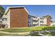 Charming multi-unit building with brick and siding, complemented by a well-kept lawn at 10150 E Virginia Ave # 7-302, Denver, CO 80247