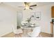 Cozy dining room with a glass-top table, modern white chairs, and stylish decor at 10150 E Virginia Ave # 7-302, Denver, CO 80247