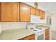 Kitchen featuring wooden cabinets, white appliances, and ample counter space at 10150 E Virginia Ave # 7-302, Denver, CO 80247