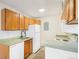 Efficient kitchen featuring wooden cabinets and white appliances at 10150 E Virginia Ave # 7-302, Denver, CO 80247