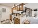Well-maintained kitchen with wood cabinets, laminate countertops, and a breakfast bar at 10150 E Virginia Ave # 7-302, Denver, CO 80247