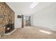 Bright living room boasts a skylight, stone fireplace, and access to a private balcony at 10150 E Virginia Ave # 7-302, Denver, CO 80247