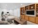Finished basement features a comfortable sitting area, built-in shelving, and a workspace at 1442 S Logan St, Denver, CO 80210