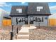 Newly renovated duplex with gray exterior, wood fence, and landscaping at 1442 S Logan St, Denver, CO 80210