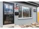 Charming home featuring a secure front door with decorative ironwork and a freshly painted gray brick exterior at 1442 S Logan St, Denver, CO 80210