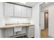 Basement laundry room with sink and cabinets at 1442 S Logan St, Denver, CO 80210