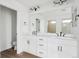 Bathroom with double vanity, modern fixtures, and large mirror in an all white design at 25323 E Warren Pl, Aurora, CO 80018
