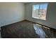 Neutral bedroom featuring carpeted floors, natural light from window, and painted walls at 25323 E Warren Pl, Aurora, CO 80018