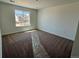 Bright bedroom features neutral paint, carpet flooring, and a large window offering ample natural light at 25323 E Warren Pl, Aurora, CO 80018