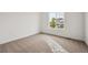 Bright bedroom with a large window showcasing neighborhood views and plush carpeting at 25323 E Warren Pl, Aurora, CO 80018