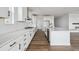 Modern kitchen featuring sleek white cabinets, stainless steel appliances, and a spacious island at 25323 E Warren Pl, Aurora, CO 80018