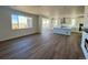 Open concept kitchen with white cabinetry, island, and stainless steel appliances at 25323 E Warren Pl, Aurora, CO 80018
