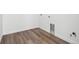 Empty laundry room features wood look flooring and white baseboards at 25323 E Warren Pl, Aurora, CO 80018