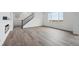 Open-concept living room showcasing hardwood floors, natural light, and staircase at 25323 E Warren Pl, Aurora, CO 80018