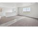 Bright and open loft space with large windows, carpeting, and plenty of natural light at 25323 E Warren Pl, Aurora, CO 80018