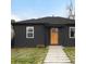 Charming dark exterior with wood front door and stone walkway at 1698 S Garfield St, Denver, CO 80210