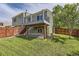 Exterior back view of house with large deck and backyard at 5713 Whitechapel St, Castle Rock, CO 80104