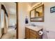 Bathroom featuring a vanity with wooden cabinets and a view into the adjacent bedroom at 5713 Whitechapel St, Castle Rock, CO 80104