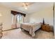 Cozy bedroom with plush carpeting, a ceiling fan, and a bright window view at 5713 Whitechapel St, Castle Rock, CO 80104