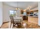Eat-in kitchen with hardwood floors and stainless steel appliances. Includes a sliding glass door to the outdoor deck at 5713 Whitechapel St, Castle Rock, CO 80104