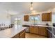 Bright kitchen with ample counter space, oak cabinets, and a sliding glass door to the outdoor deck at 5713 Whitechapel St, Castle Rock, CO 80104