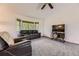 Comfortable living room offering natural light from bay window and neutral-toned carpeting at 5713 Whitechapel St, Castle Rock, CO 80104