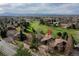 Aerial view of a golf course community nestled in the mountains and green landscape, showcasing an upscale neighborhood and scenic beauty at 5745 W Mansfield Ave # 265, Denver, CO 80235