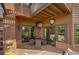 Inviting back patio with outdoor seating, a mounted TV, and access to the golf course, perfect for relaxing and entertaining at 5745 W Mansfield Ave # 265, Denver, CO 80235