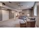 Finished basement boasts plush carpet, neutral paint, and comfortable seating near the bedroom, creating a versatile and inviting living space at 5745 W Mansfield Ave # 265, Denver, CO 80235