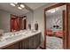 Well-lit bathroom features a modern vanity, stylish mirror, and an adjacent sitting room, offering a relaxing, spa-like atmosphere at 5745 W Mansfield Ave # 265, Denver, CO 80235