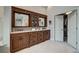Bathroom boasting custom cabinetry, double sinks, and a walk-in closet offering functionality and luxury at 5745 W Mansfield Ave # 265, Denver, CO 80235