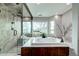 Bathroom featuring a walk-in shower, soaking tub, and scenic views creating a spa-like experience at 5745 W Mansfield Ave # 265, Denver, CO 80235
