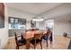 Dining room with hardwood floors, modern lighting, and an adjacent bar area at 5745 W Mansfield Ave # 265, Denver, CO 80235