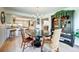 Open-concept view of the kitchen and dining room with wooden floors, modern light fixtures, and black countertops at 5745 W Mansfield Ave # 265, Denver, CO 80235