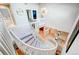Bright foyer featuring a curved staircase, elegant lighting, and hardwood flooring creating an inviting entrance to the home at 5745 W Mansfield Ave # 265, Denver, CO 80235