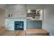 Modern living room featuring a fireplace, built-in bar, and wood flooring at 5745 W Mansfield Ave # 265, Denver, CO 80235