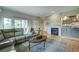 Comfortable living room with a gray sofa, fireplace, modern cabinets, and wood floors at 5745 W Mansfield Ave # 265, Denver, CO 80235