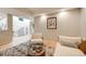 Inviting living room with a winding staircase, cozy seating, stylish rug, and bright lighting at 5745 W Mansfield Ave # 265, Denver, CO 80235