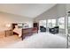Main bedroom featuring vaulted ceilings, large windows, neutral colors, and ample space for relaxation and rest at 5745 W Mansfield Ave # 265, Denver, CO 80235