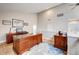 Bright home office featuring hardwood floors, skylights, and an executive desk creating a professional atmosphere at 5745 W Mansfield Ave # 265, Denver, CO 80235